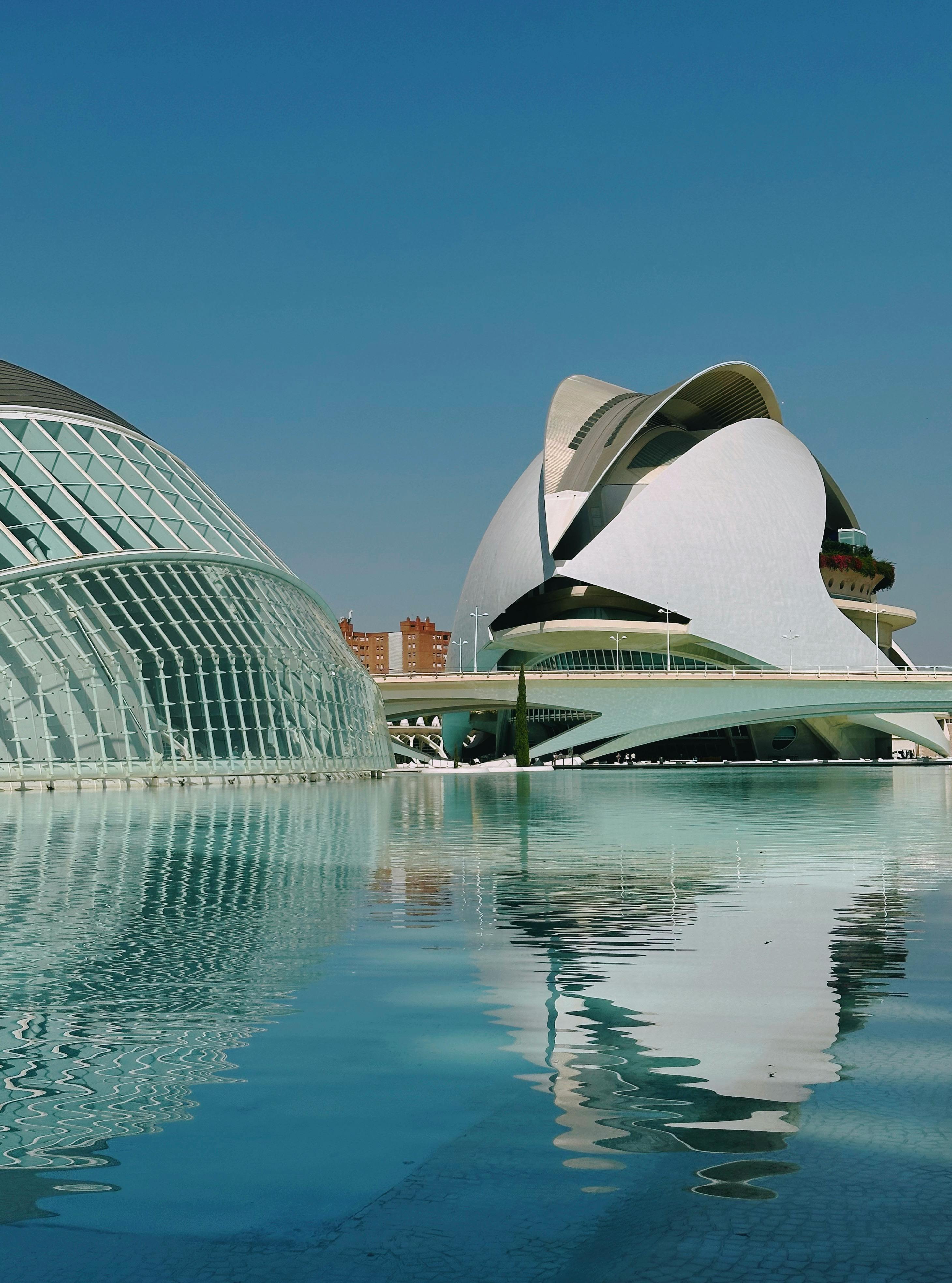 Modern architecture of City of Arts and Sciences in Valencia, reflected in calm water.