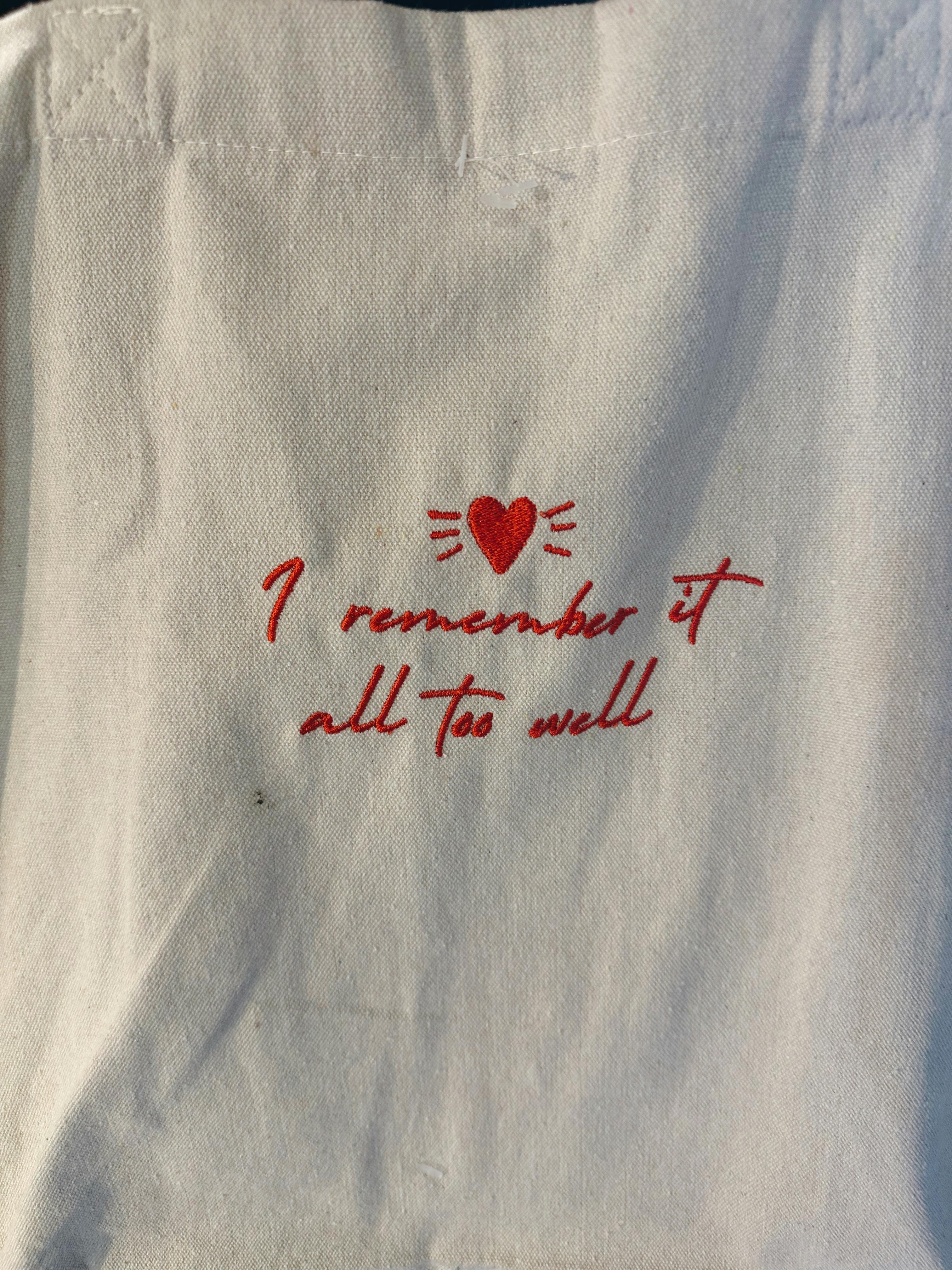 Simple fabric with red heart and text embroidery, adding charm.