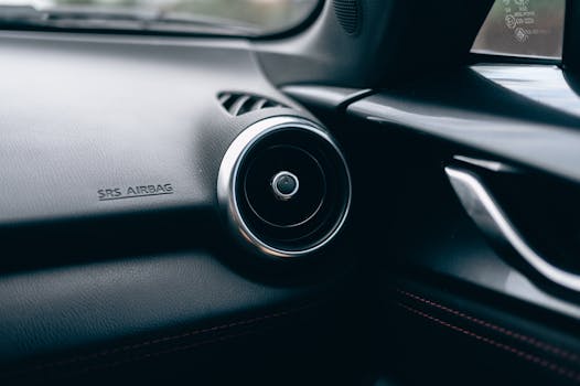 Close-up of a car interior featuring an air vent and SRS airbag text on the dashboard.