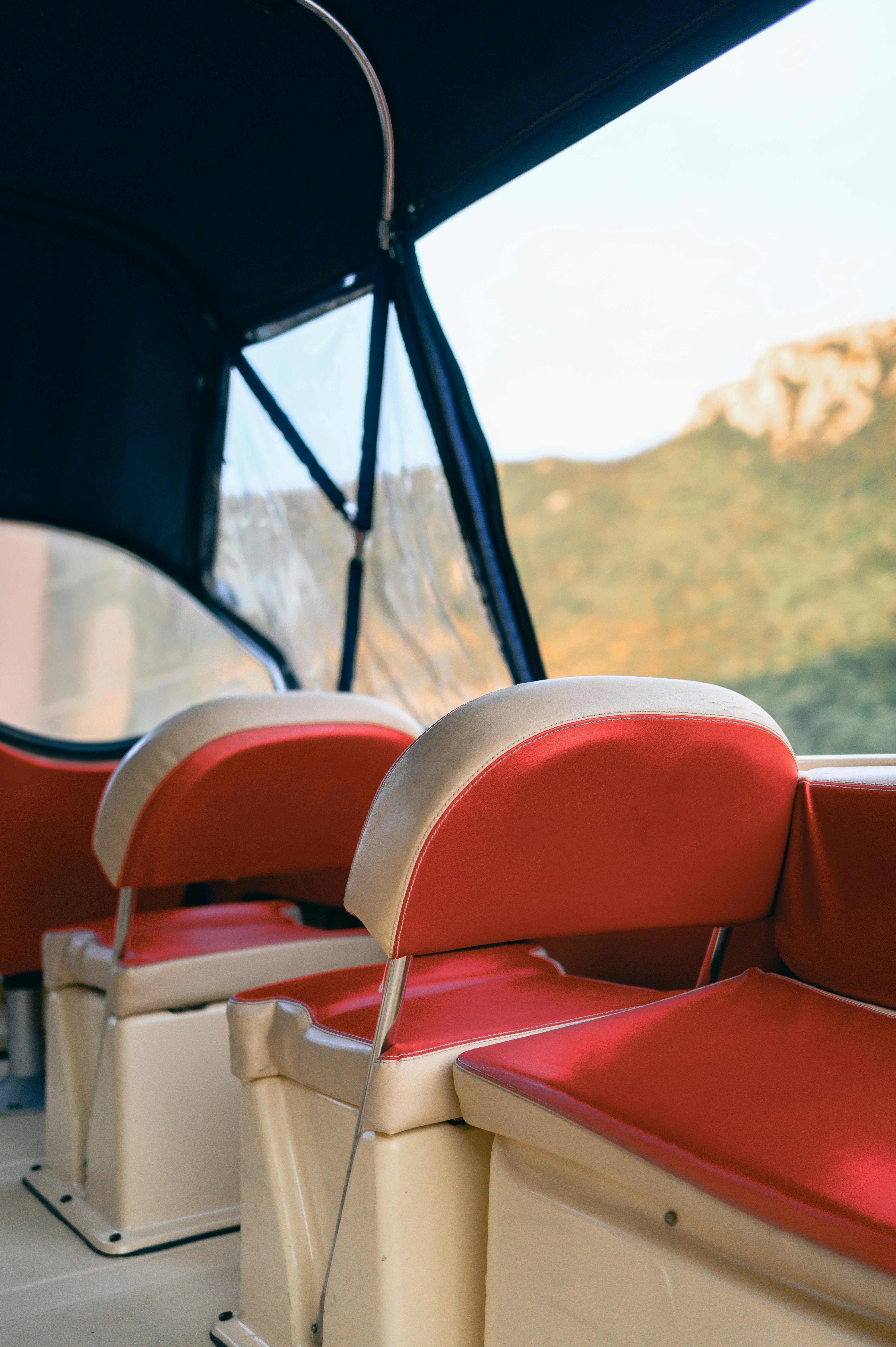 interior of a boat with red seats on a sunny day