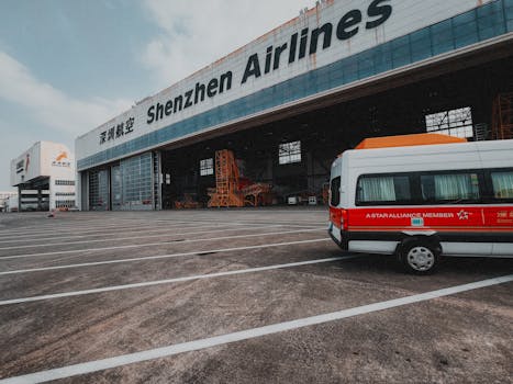 Shenzhen Airlines hangar with a parked van depicting air travel infrastructure.