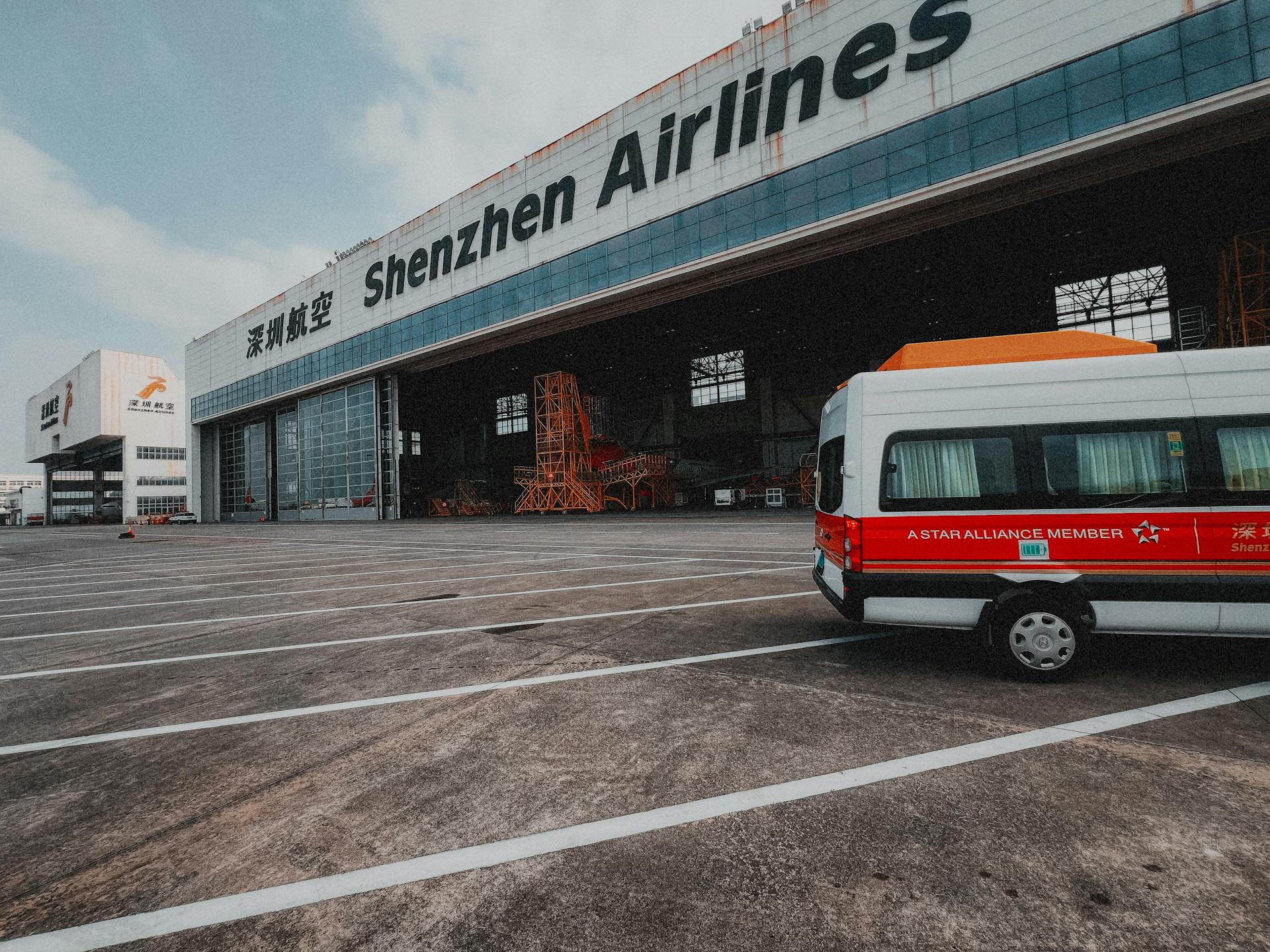 Shenzhen Airlines hangar with a parked van depicting air travel infrastructure.