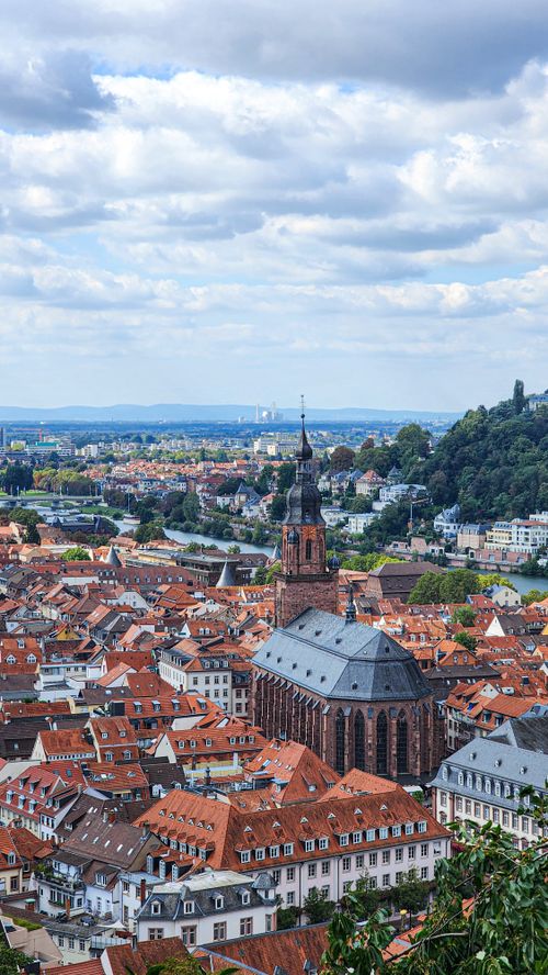 Free Aerial view of Heidelberg's historic Old Town featuring the iconic Church of the Holy Spirit. Stock Photo