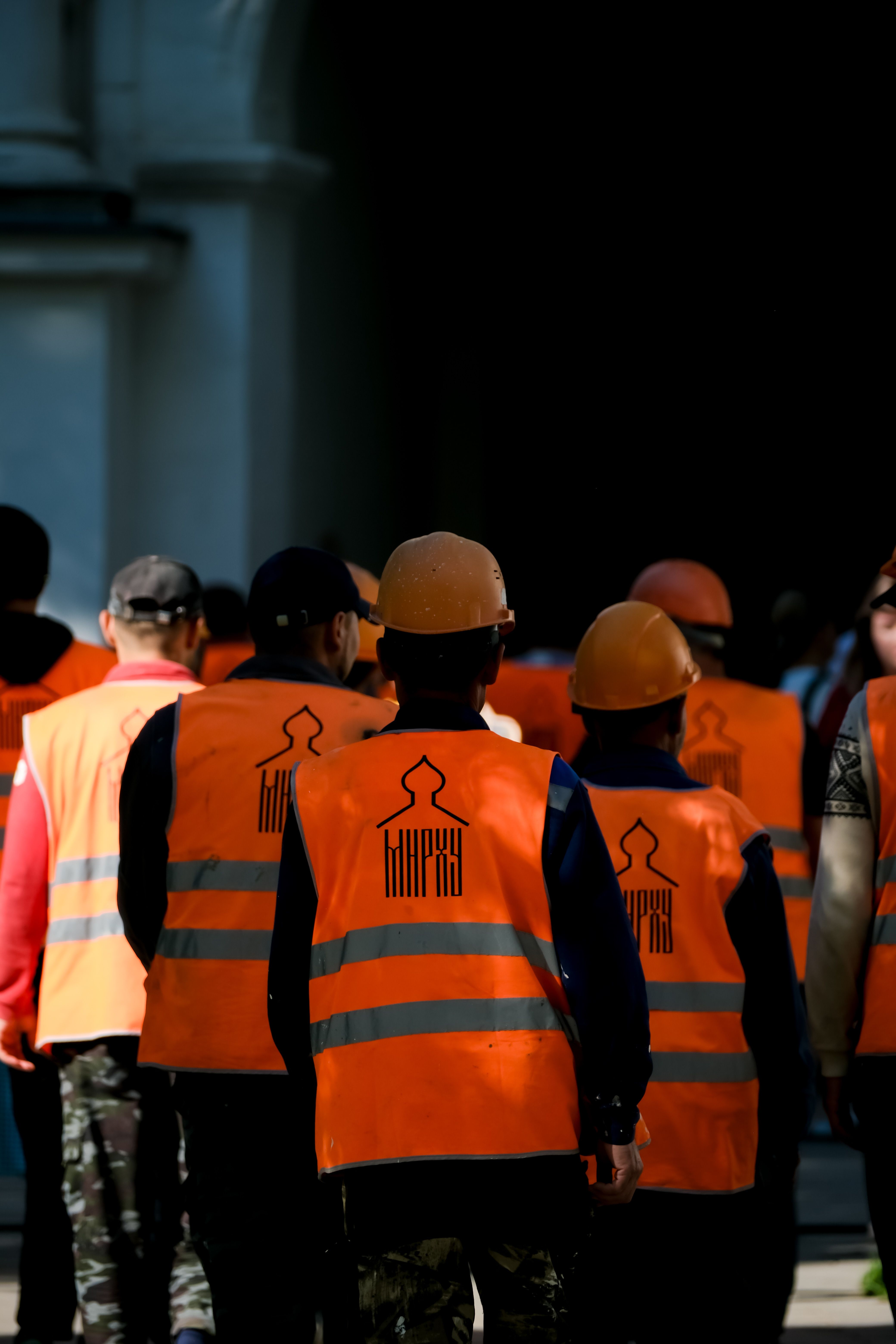 Construction Workers in Orange Safety Vests in Moscow · Free Stock Photo