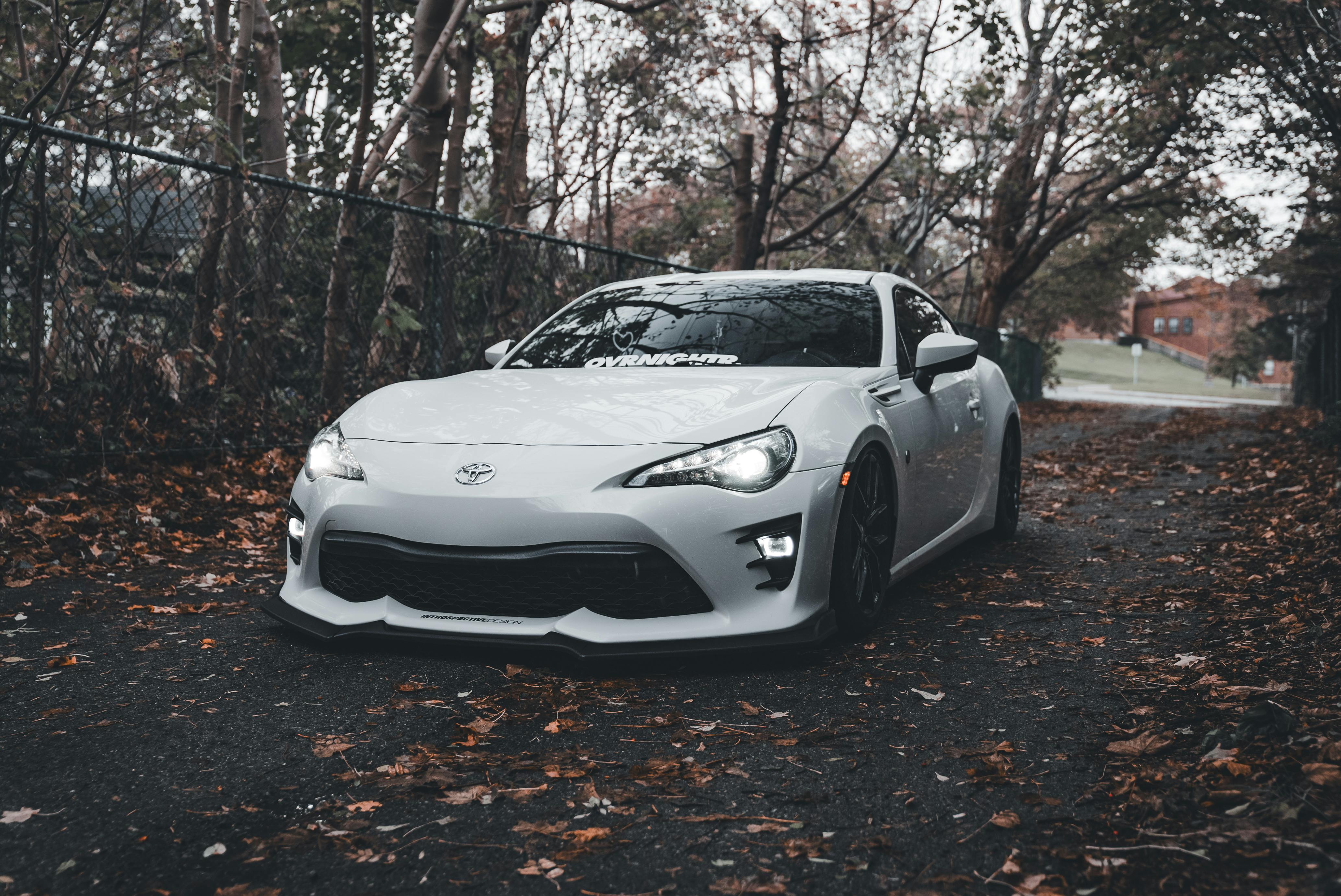 Sleek White Sports Car in Autumn Outdoor Setting