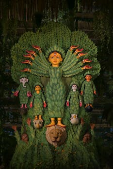 Beautifully crafted Durga idol made from leaves at a Kolkata pandal during Durga Puja.
