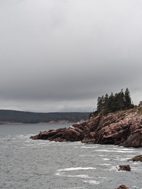 Free Stormy skies over the rugged rocky coastline of Cape Breton Island, NS, Canada. Stock Photo