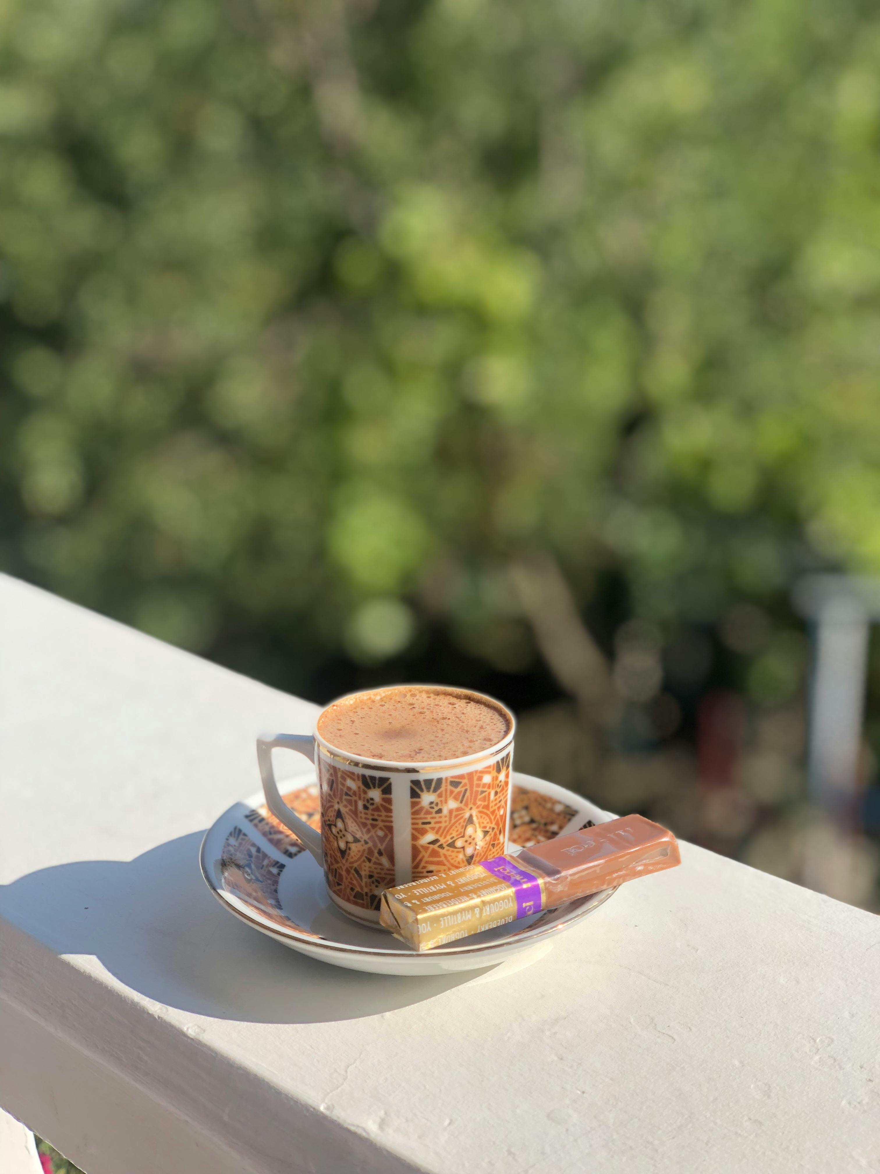 cup of coffee with chocolates on balcony