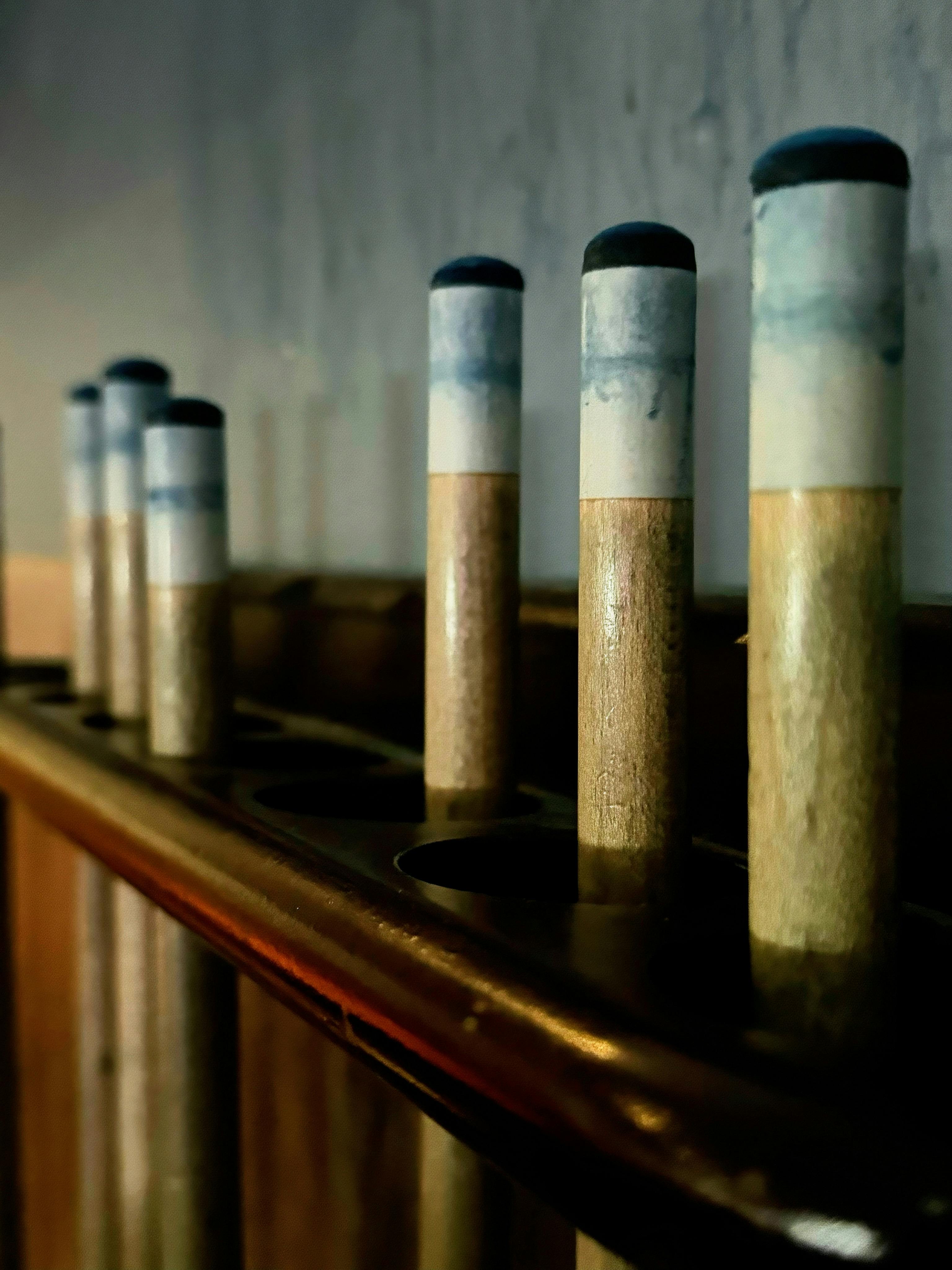 A close-up view of pool cue tips lined up in a rack, emphasizing texture and alignment.