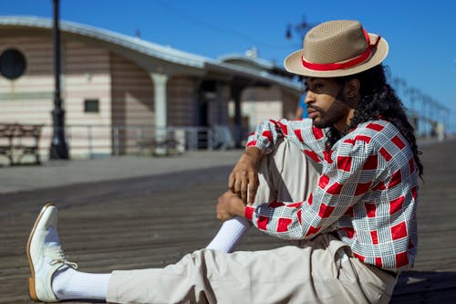 Free Man in Red and White Dress Shirt on Wooden Surface Stock Photo