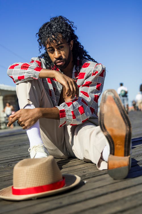 Man Sitting on Wooden Surface