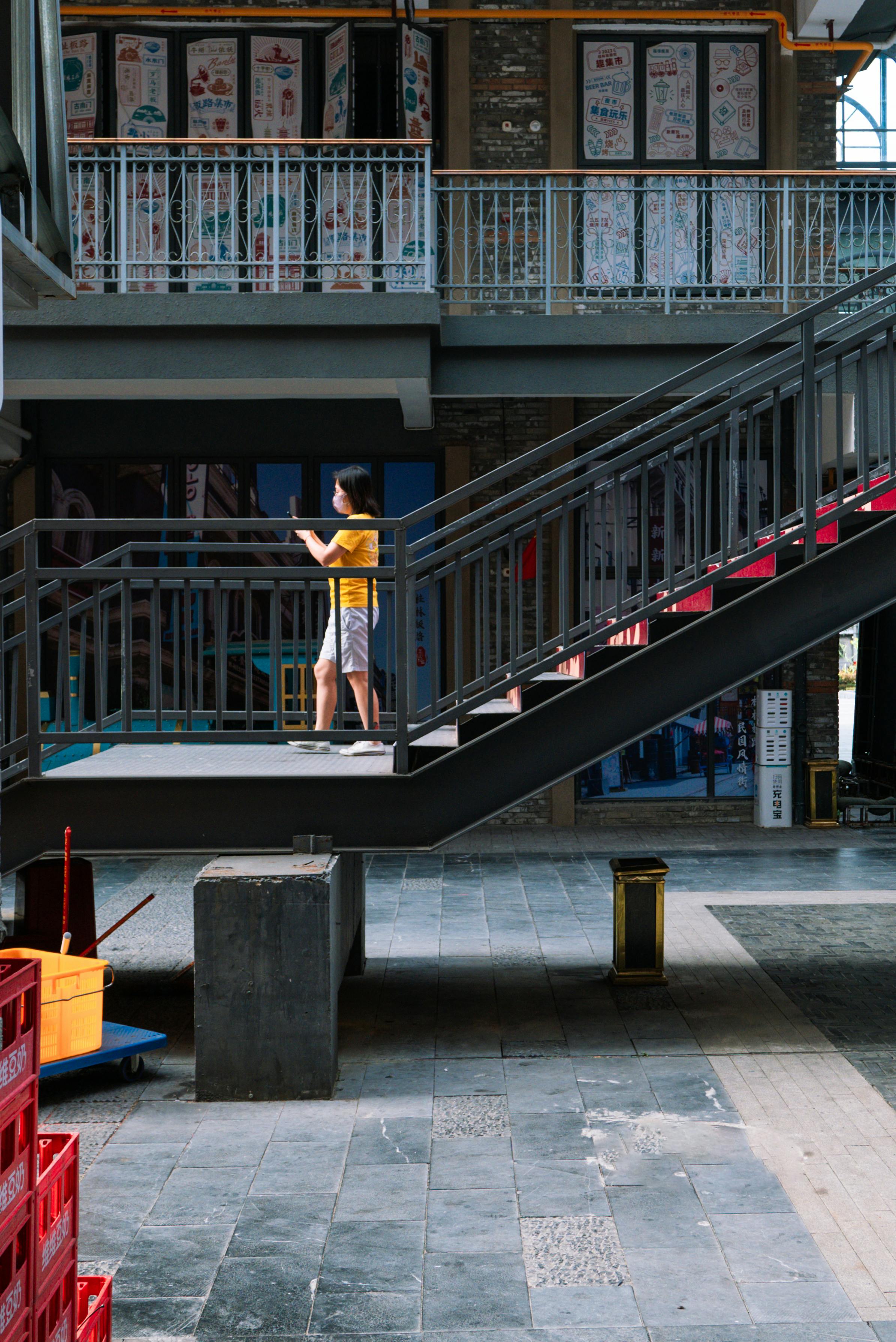 urban staircase with pedestrian in bright attire