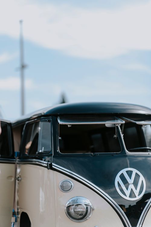 Free Vintage black and white Volkswagen van parked outdoors on a sunny day. Stock Photo