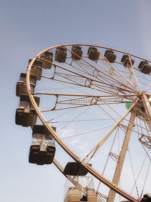 Free A giant Ferris wheel with gondolas under a clear blue sky. Captured in natural light. Stock Photo