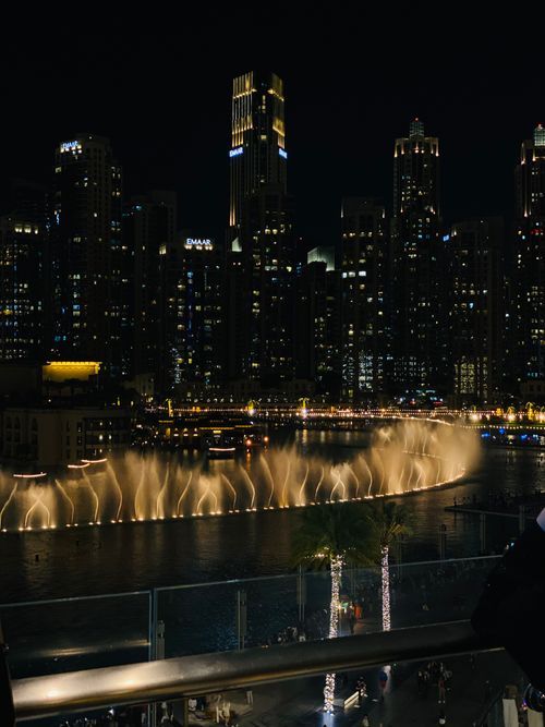 Free Captivating night view of Dubai's famous fountain show with illuminated skyscrapers. Stock Photo