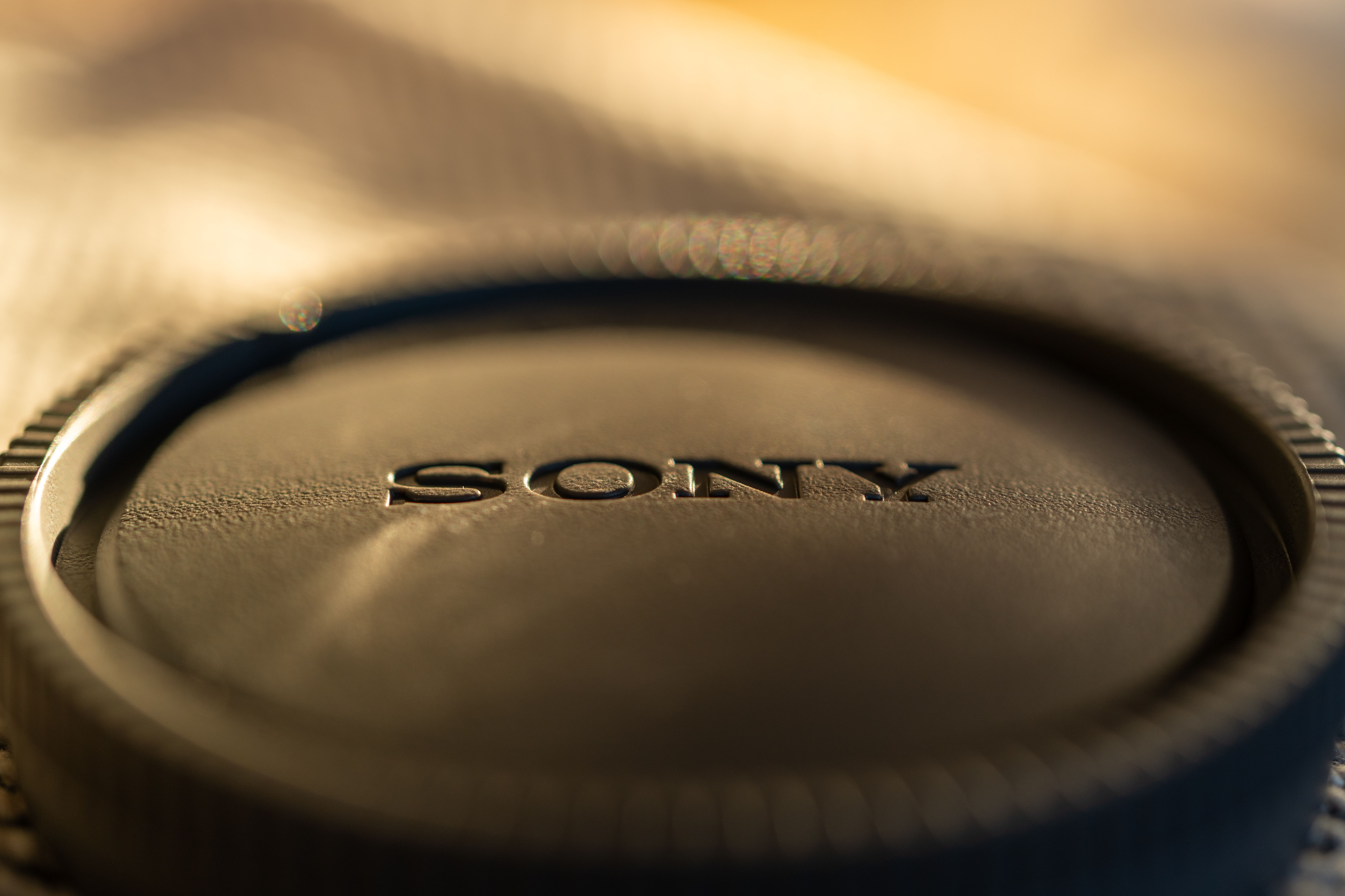 Close-up of Camera Lens Cap in Soft Light · Free Stock Photo