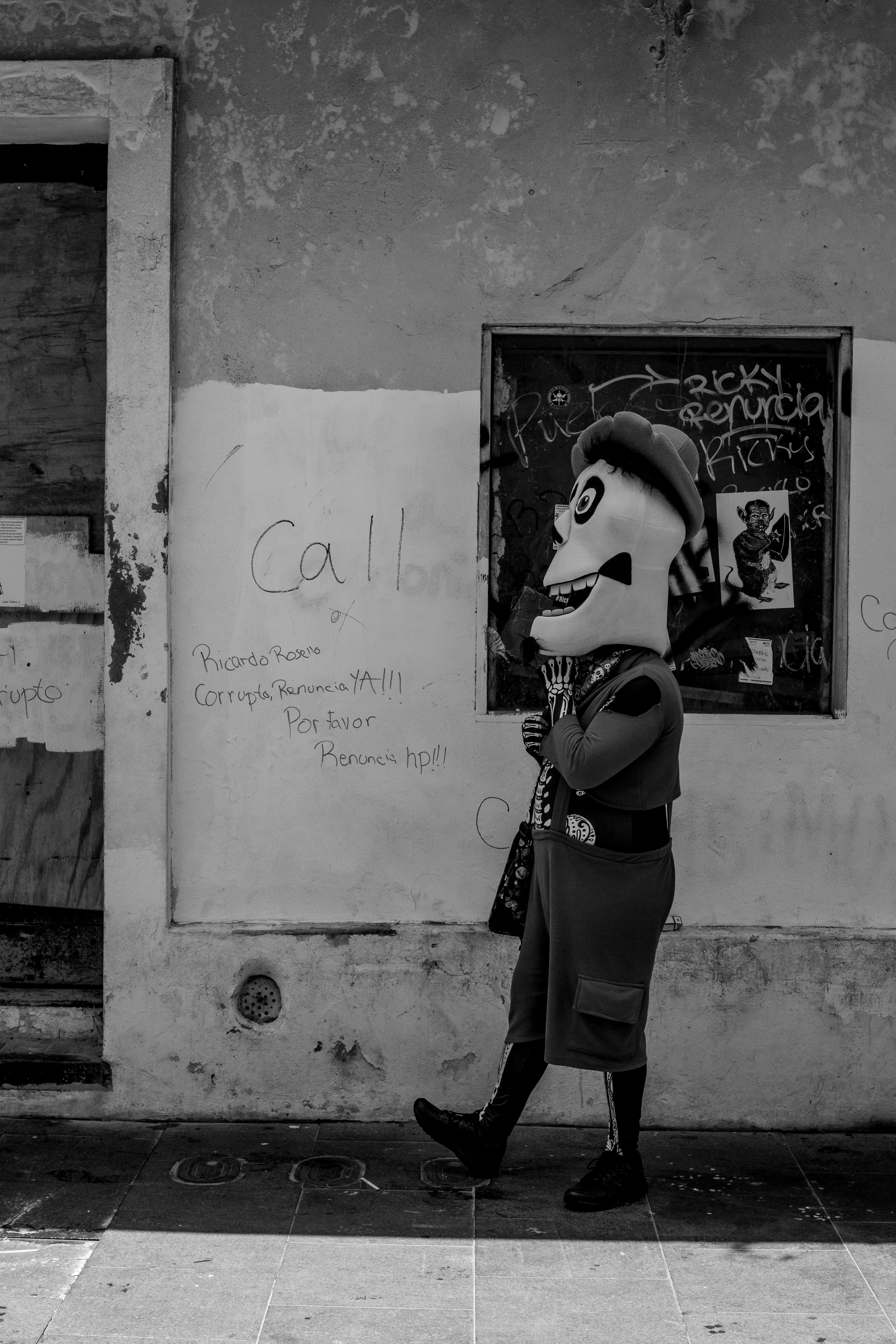 man wearing mask beside wall