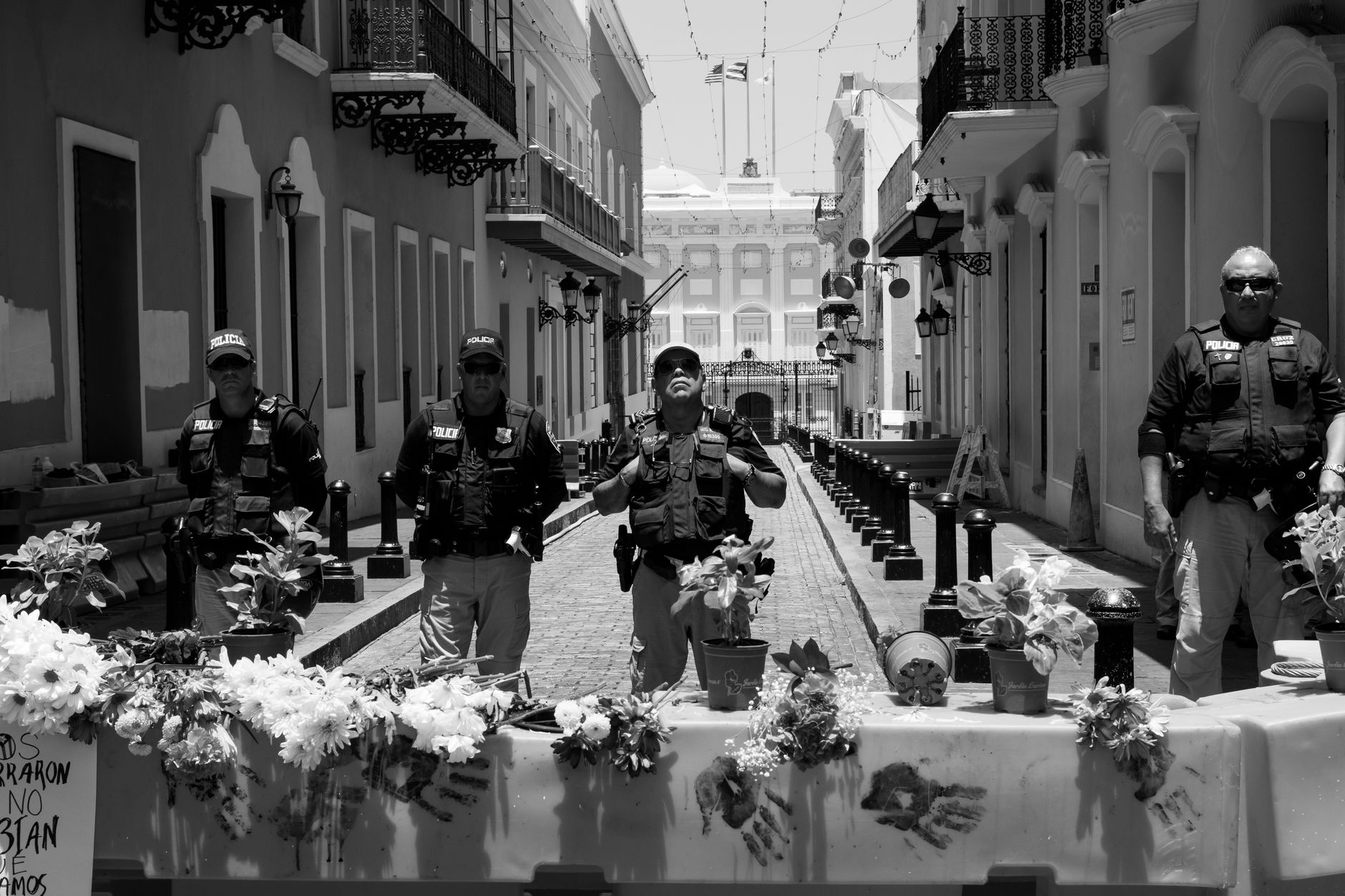 Soldiers in uniform patrolling a public plaza in San Salvador, El Salvador.