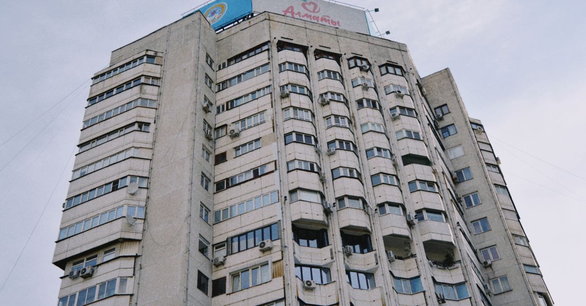 Concrete high-rise building with architectural details in Almaty, Kazakhstan.