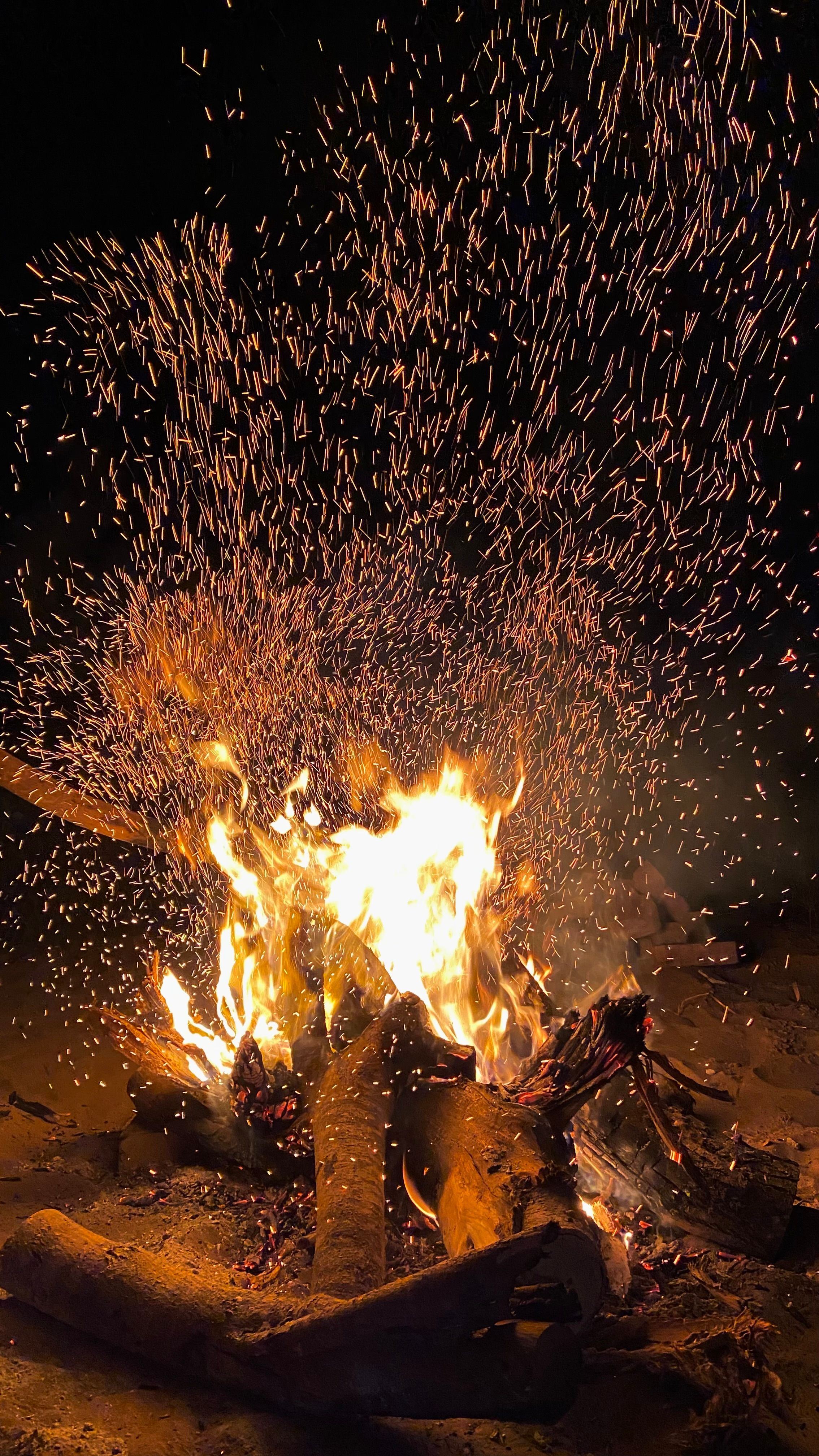 Captivating Campfire with Vibrant Sparks at Night · Free Stock Photo