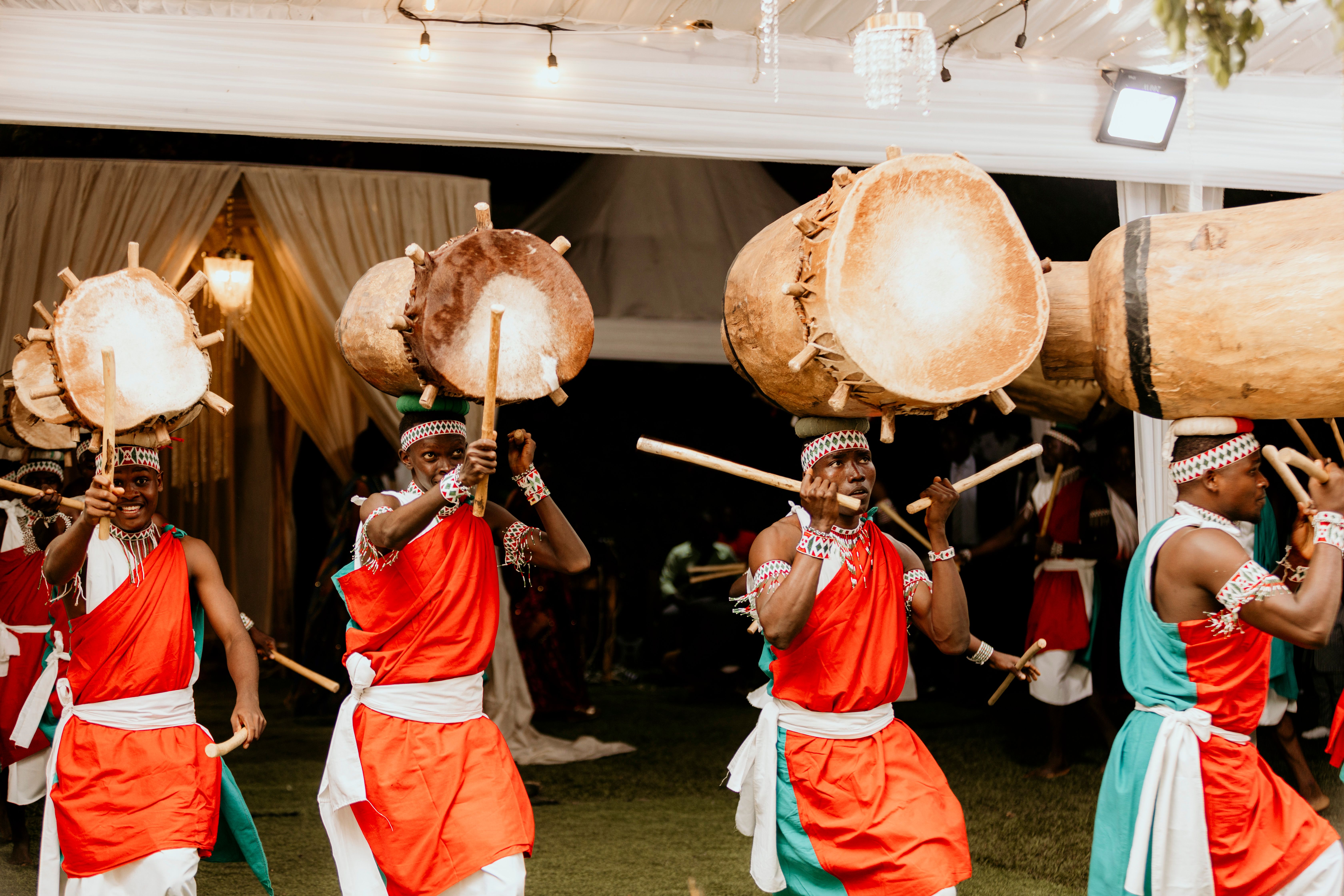 Vibrant ceremonial dancers with drums in Central Africa — the Ngombi harp and percussion instruments create a sonic container that guides the inner journey iboga catalyses
