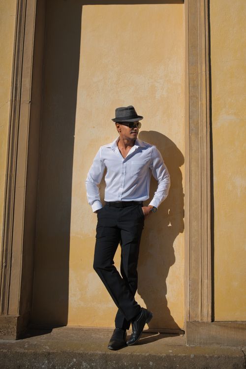 Free A fashionable man posing at Sanssouci Palace in Potsdam, Germany. Stock Photo