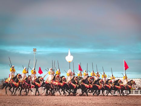 A captivating scene of Moroccan horsemen performing a traditional Fantasia charge in El Jadida.
