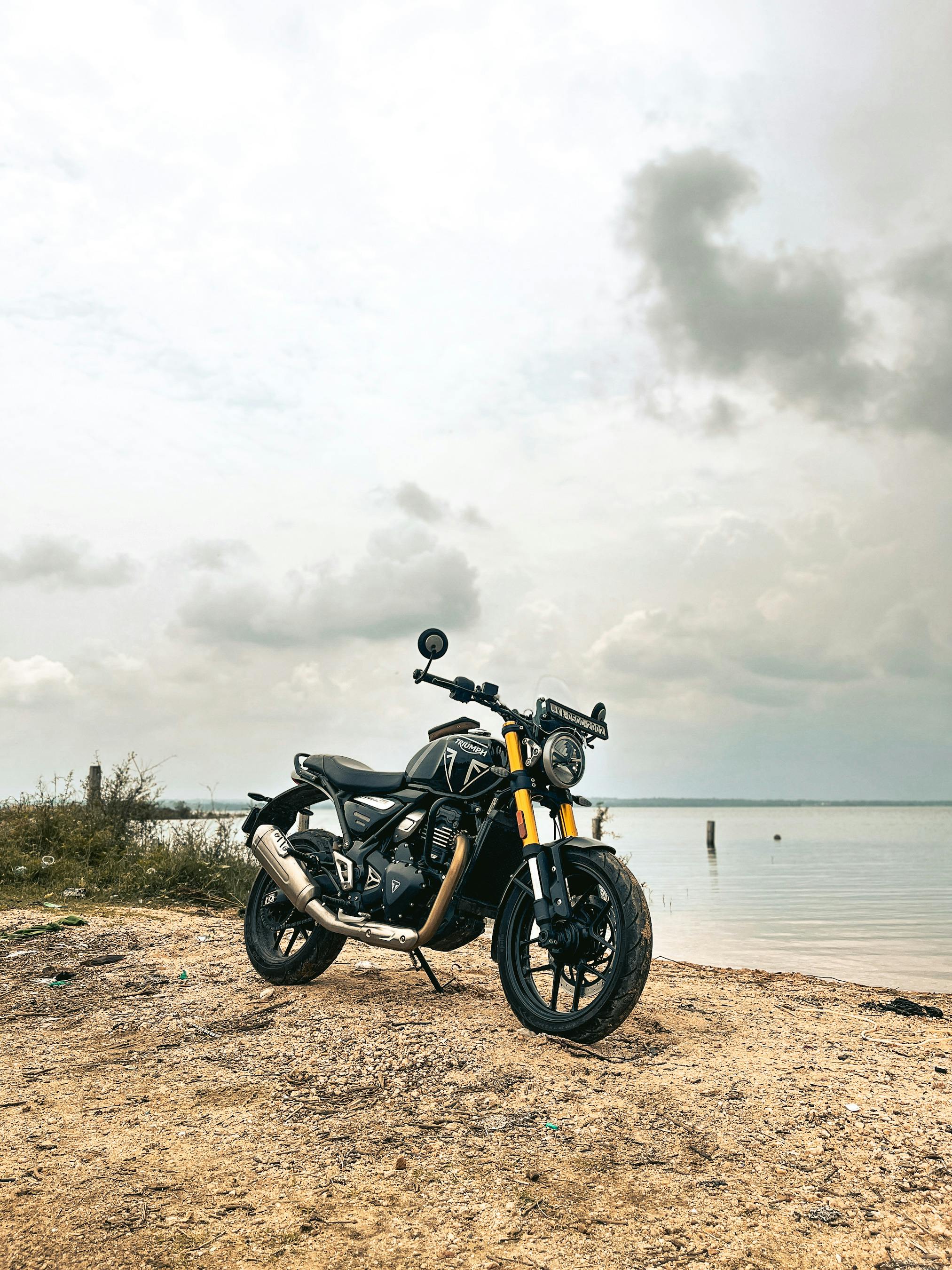 black motorcycle by tranquil lakeside in bengaluru