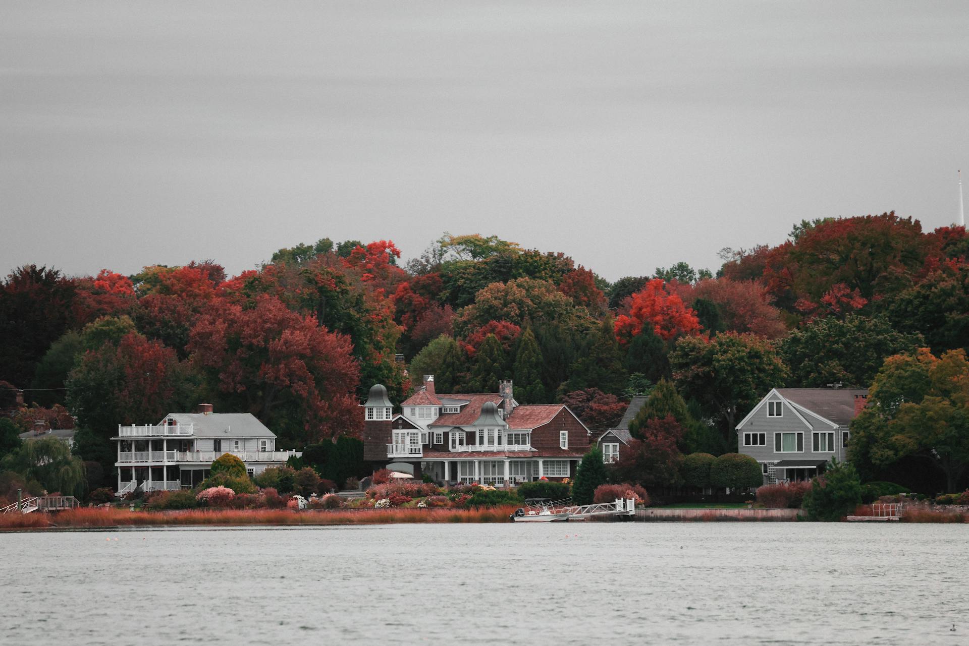 Charming waterfront homes nestled in vibrant autumn foliage in Stamford, Connecticut.