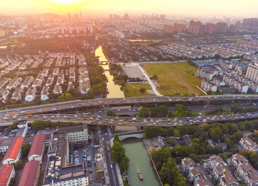 A breathtaking aerial view of Suzhou, China capturing the city's landscape at sunset.
