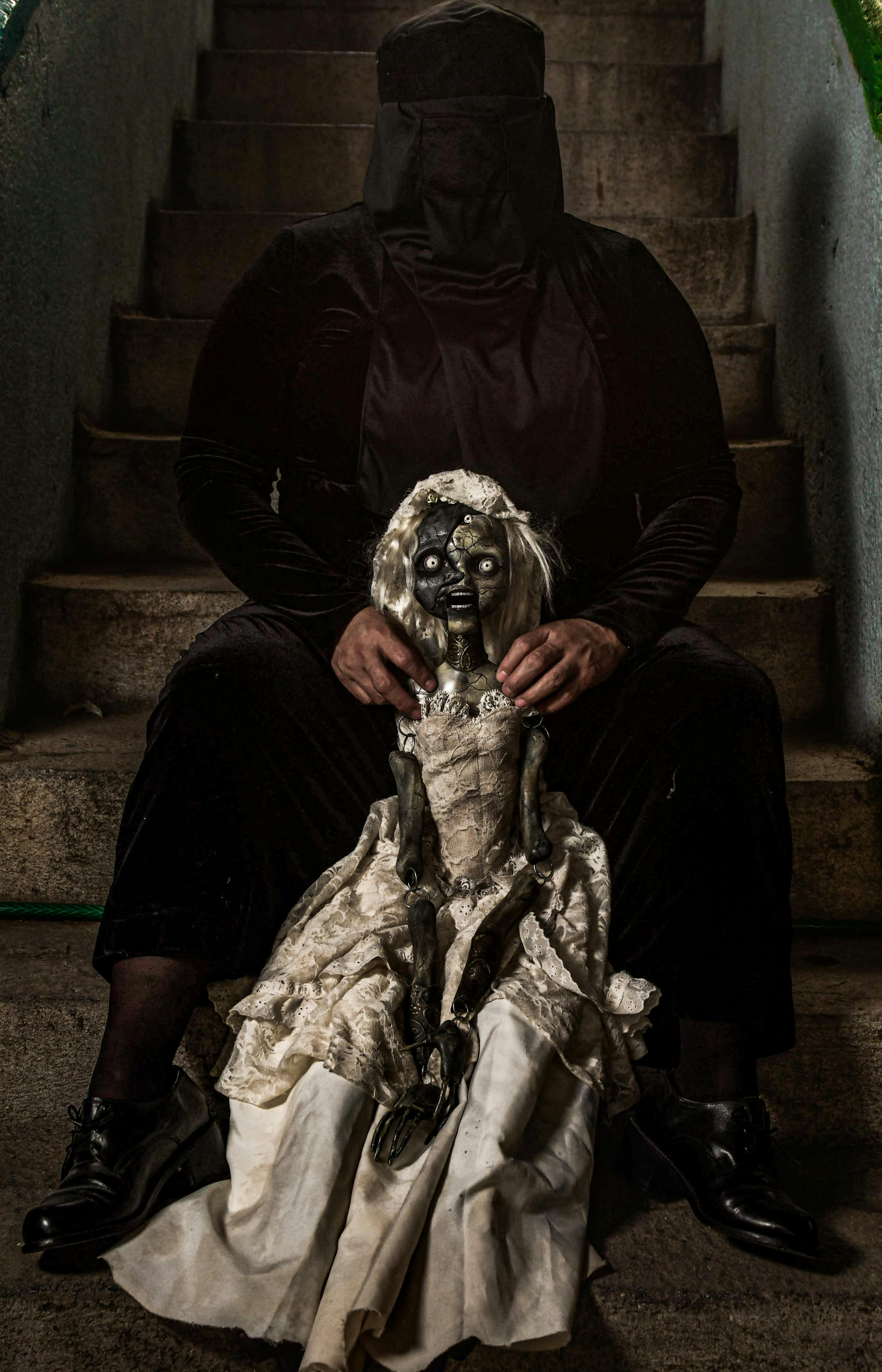 dark artistic portrait with mysterious doll