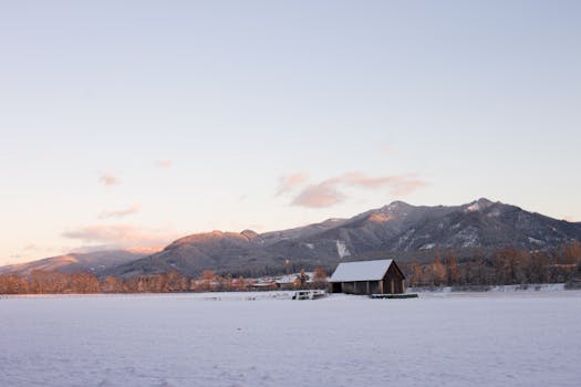 Scenic winter view of snow-covered mountains and fields in Krieglach, Austria.