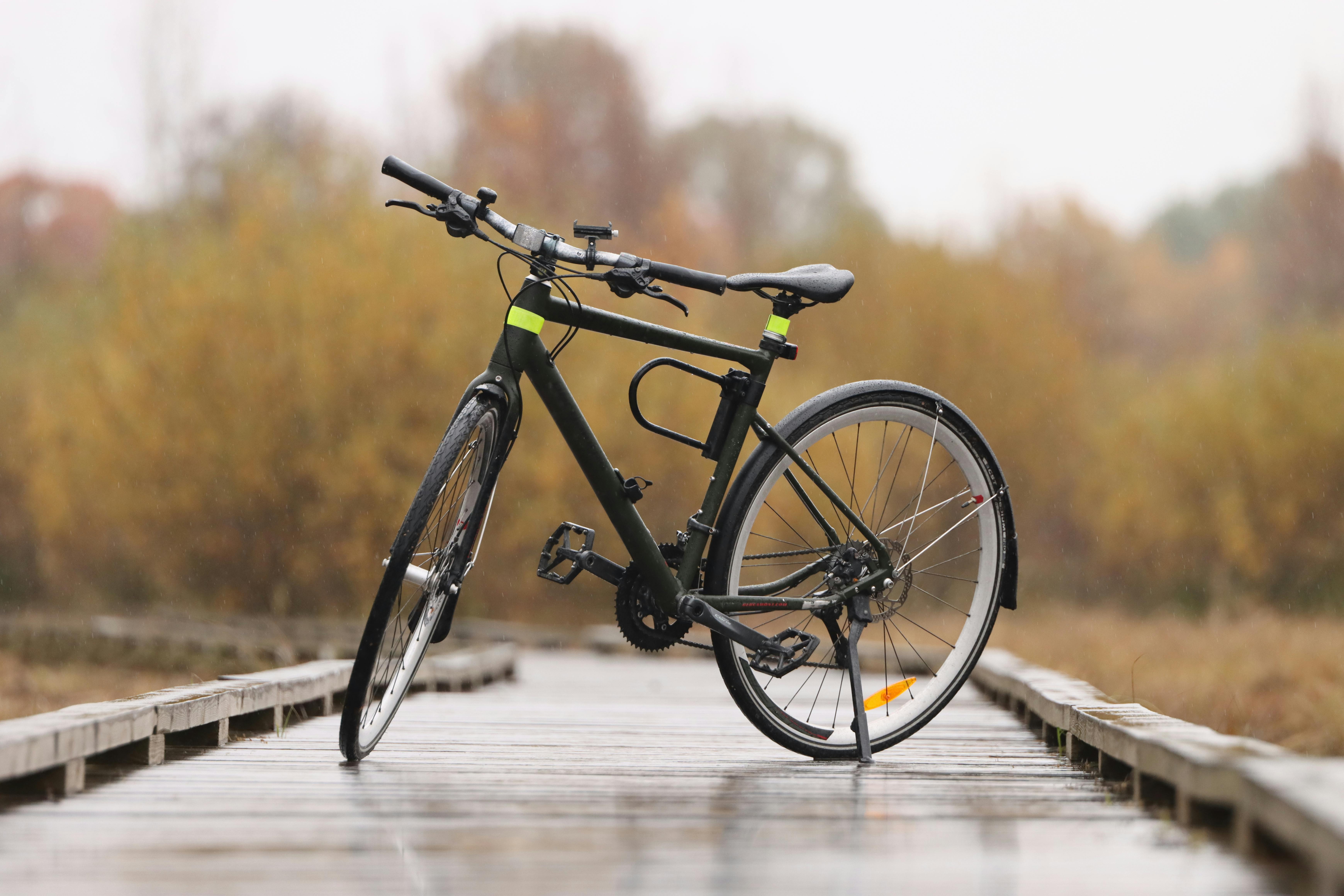 bicycle on wet boardwalk in autumn