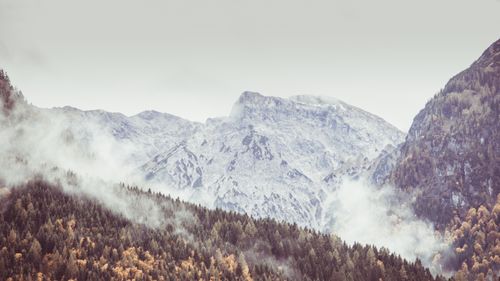 Free Breathtaking view of mist-covered mountains in Tirol, Austria, during autumn. Stock Photo