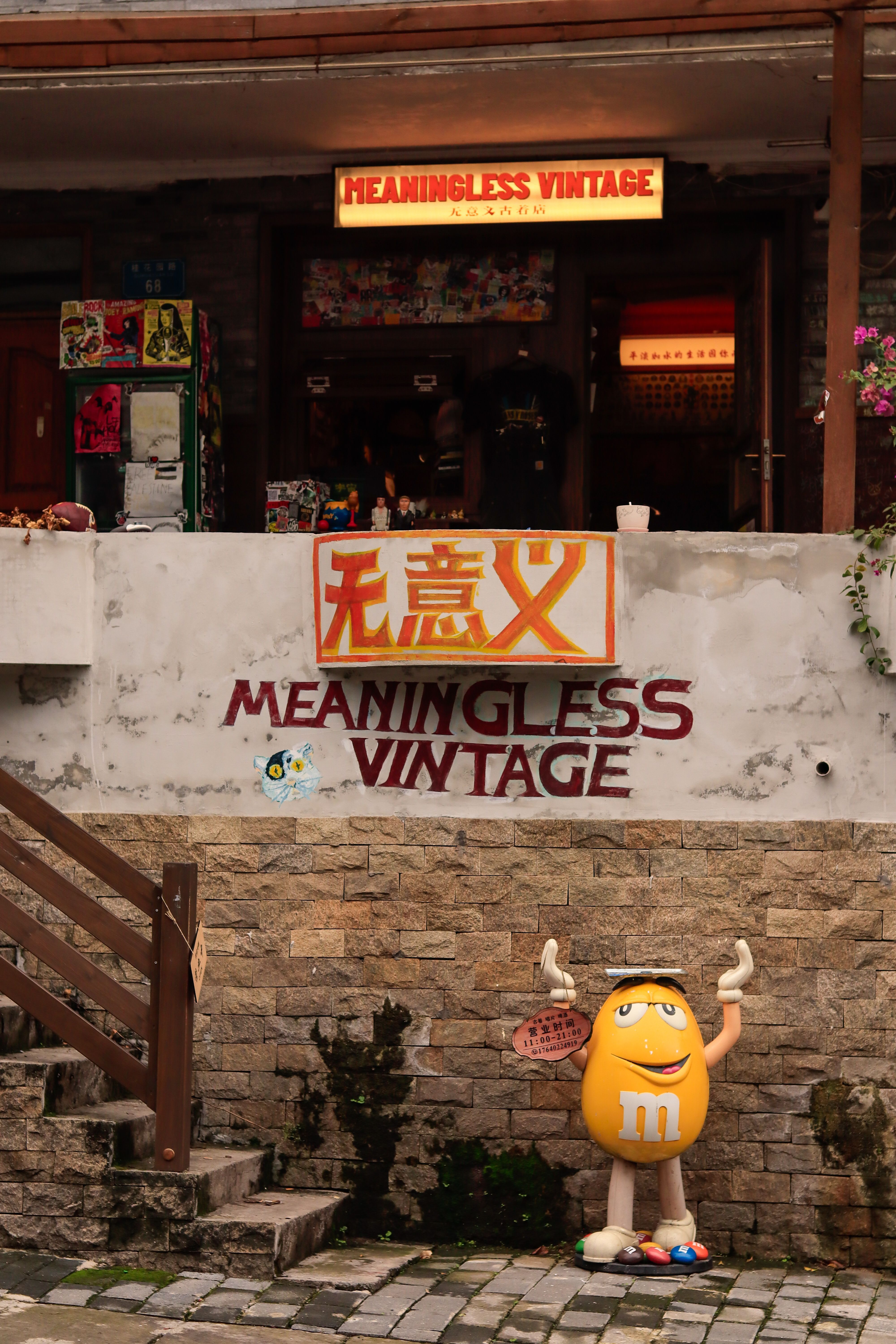A charming vintage store entrance featuring a yellow candy mascot and bold signage.