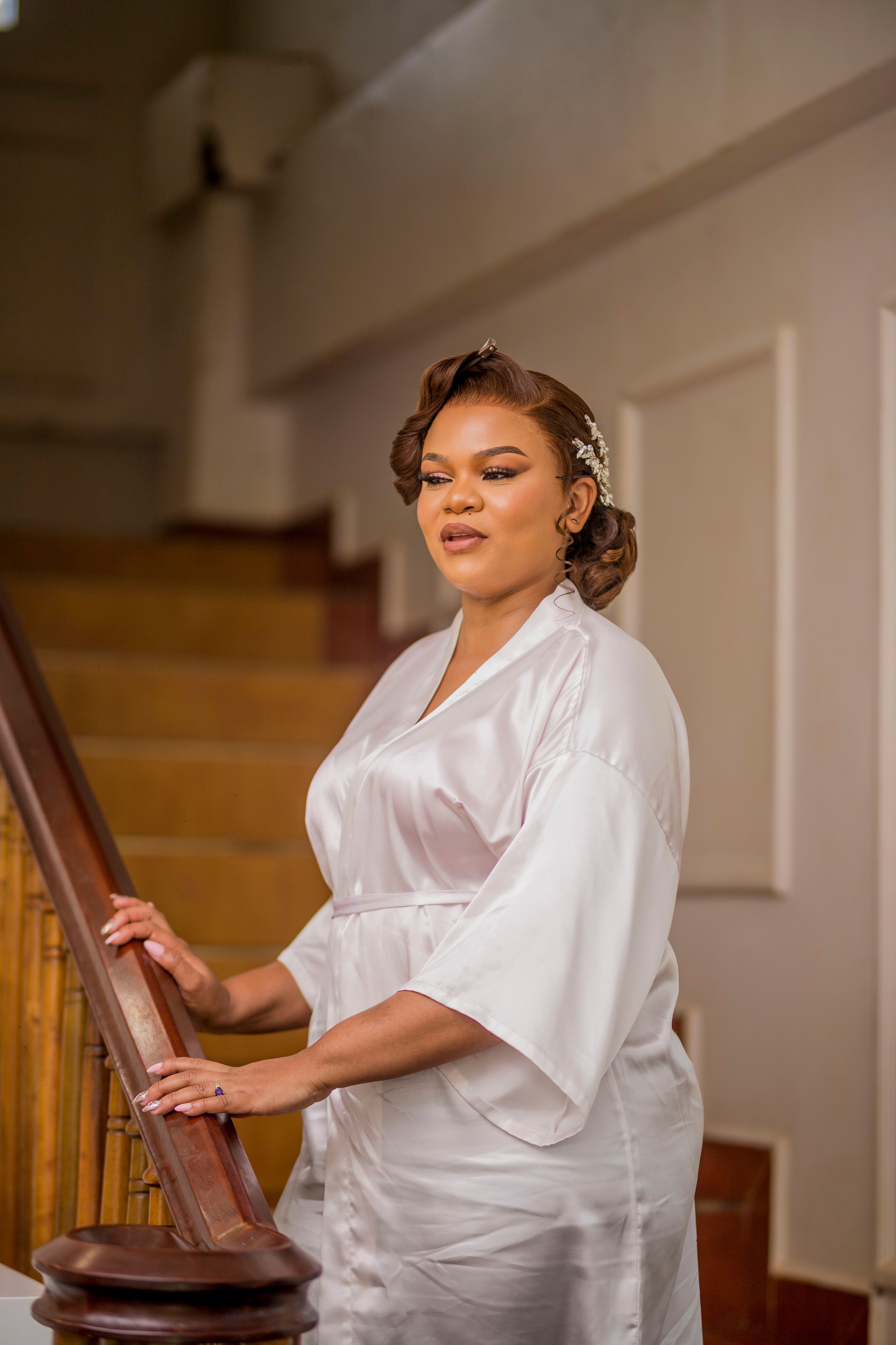 Elegant Woman in Bridal Robe on Staircase · Free Stock Photo