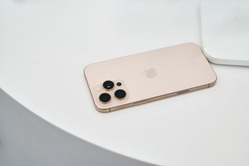 Free A sleek smartphone with a minimalist design lying on a white surface. Perfect for tech themes. Stock Photo