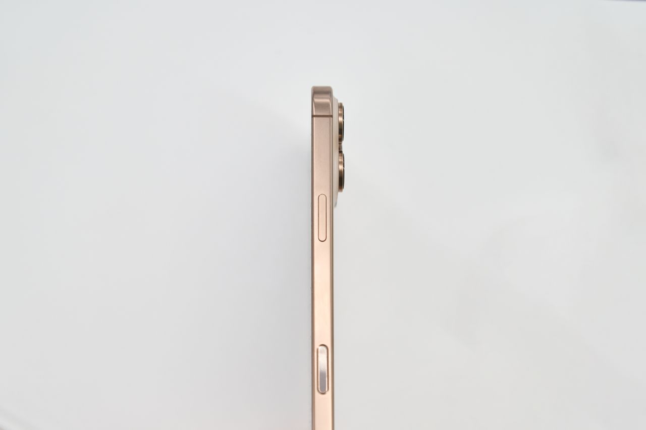 minimalist side view of a gold smartphone on white background