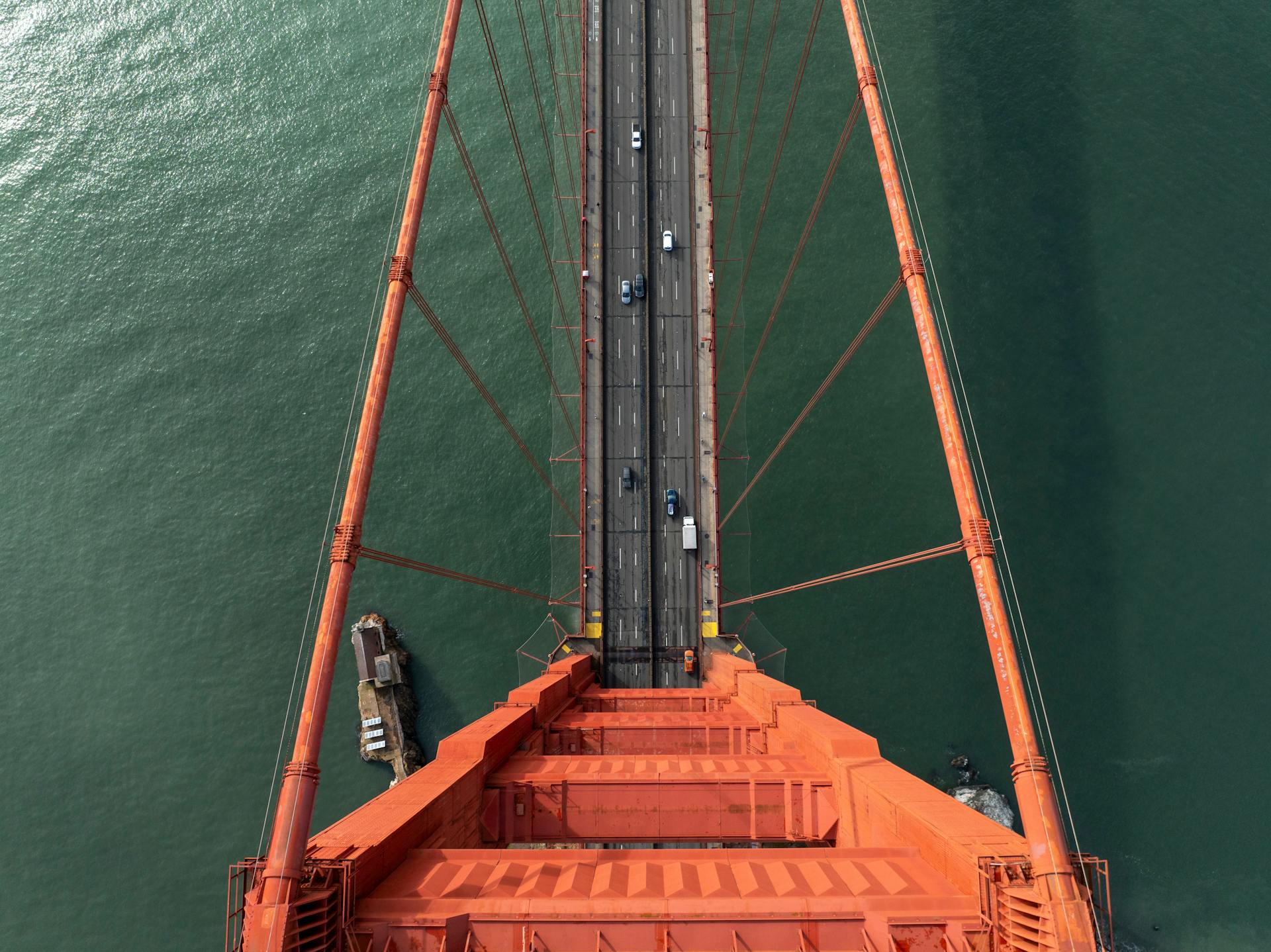 Stunning aerial perspective of the Golden Gate Bridge with vehicles crossing over the water.