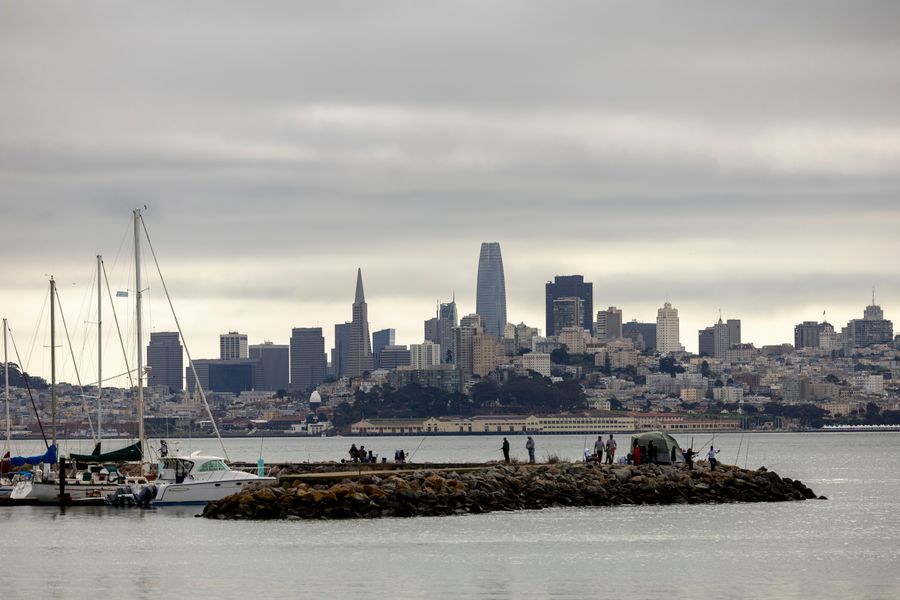 The San Francisco skyline seen across the bay from the northern waterfront, with sailboats moored inshore
