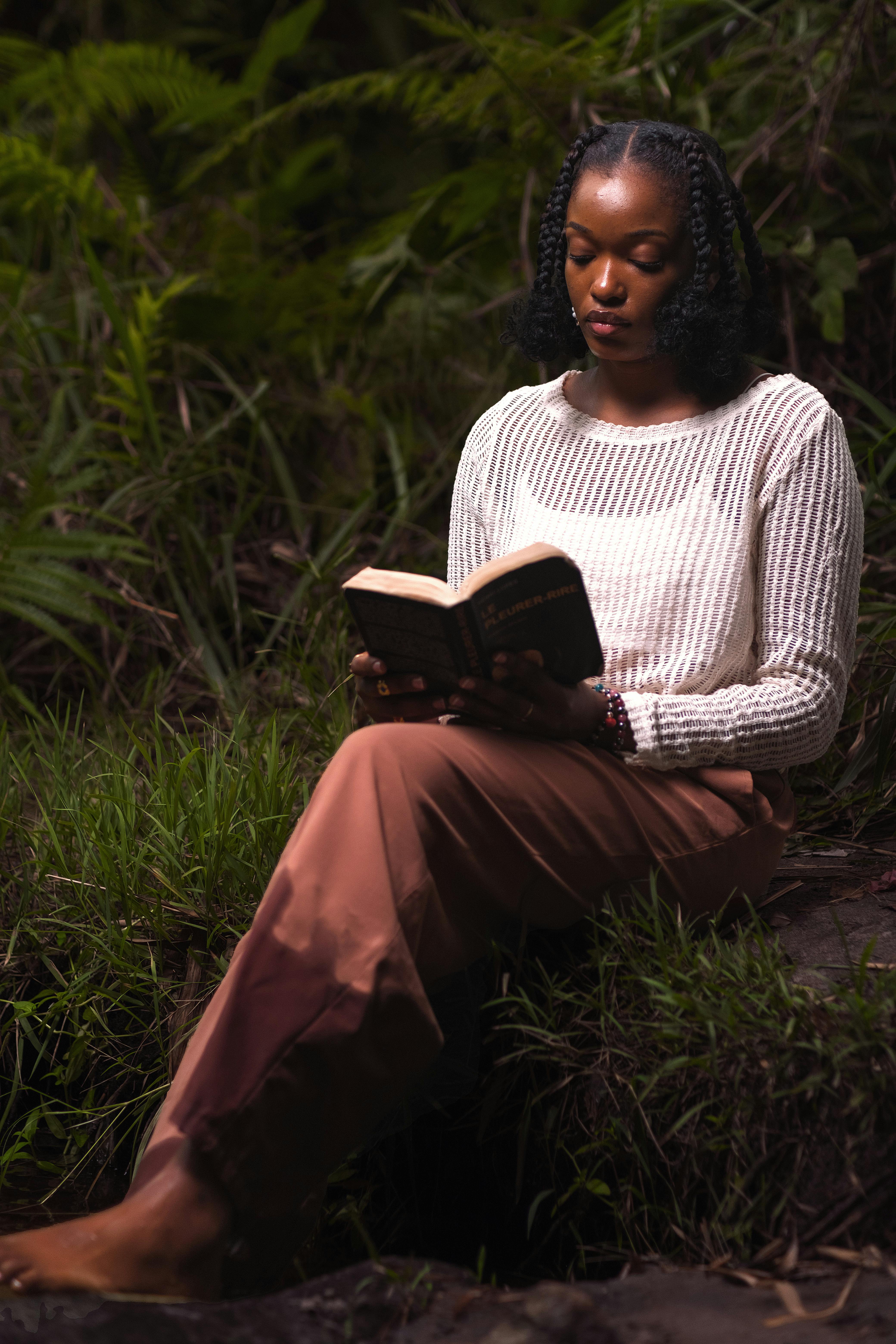 woman reading in a serene forest setting