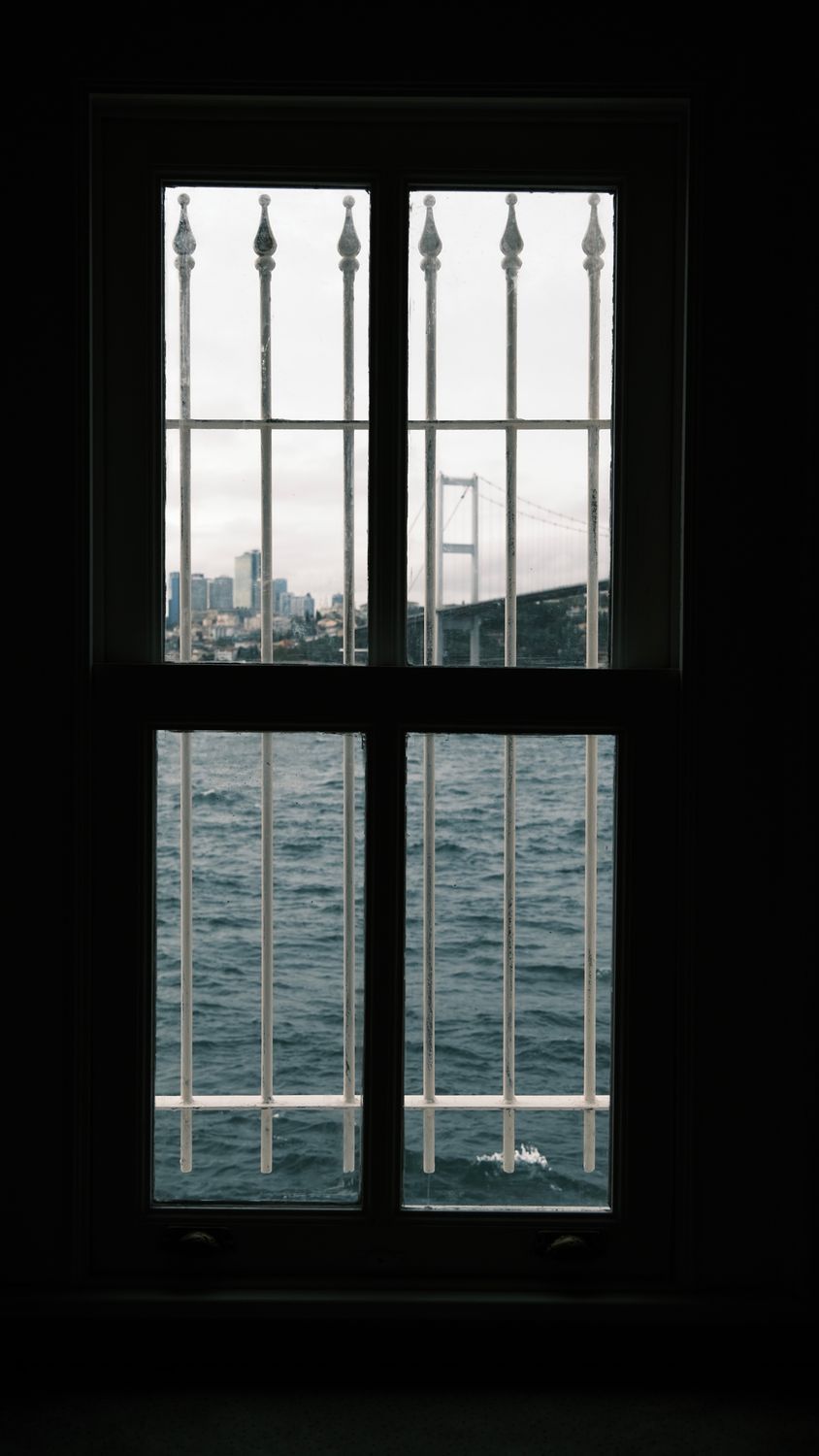 Cityscape View through Window Bars · Free Stock Photo