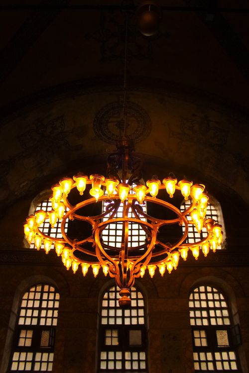 Free Warm glowing chandelier inside Hagia Sophia, showcasing its grand architectural elegance. Stock Photo