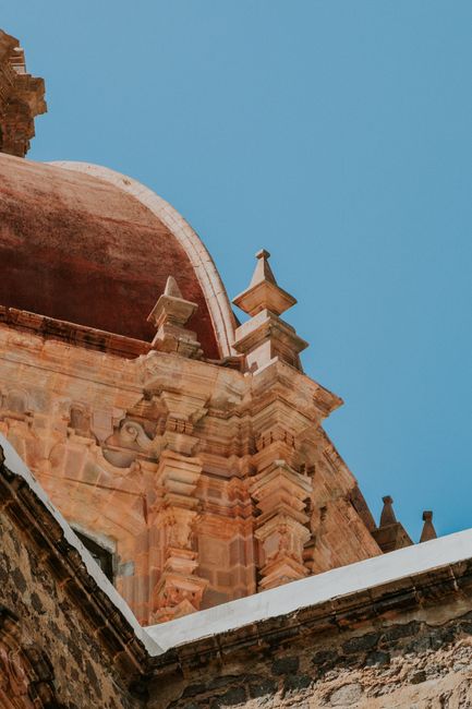 Stunning Baroque architecture of Guanajuato, Mexico, showcased against a clear blue sky.