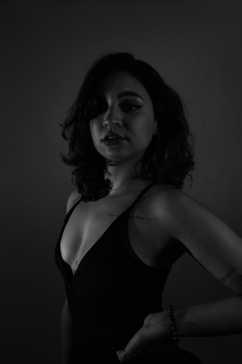 Free Striking black and white portrait of a woman with a dramatic pose and lighting. Stock Photo