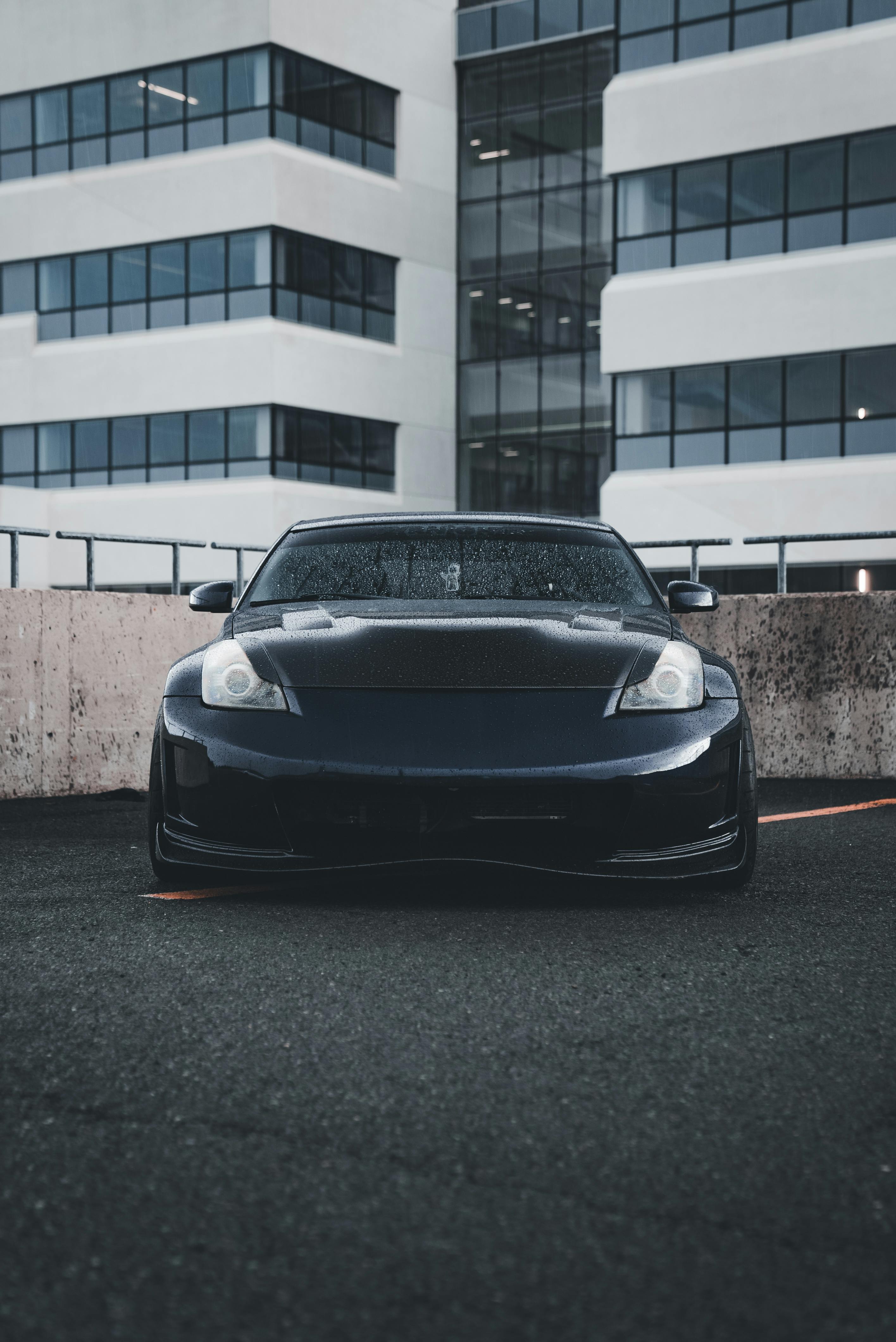 sleek dark sports car parked in urban setting