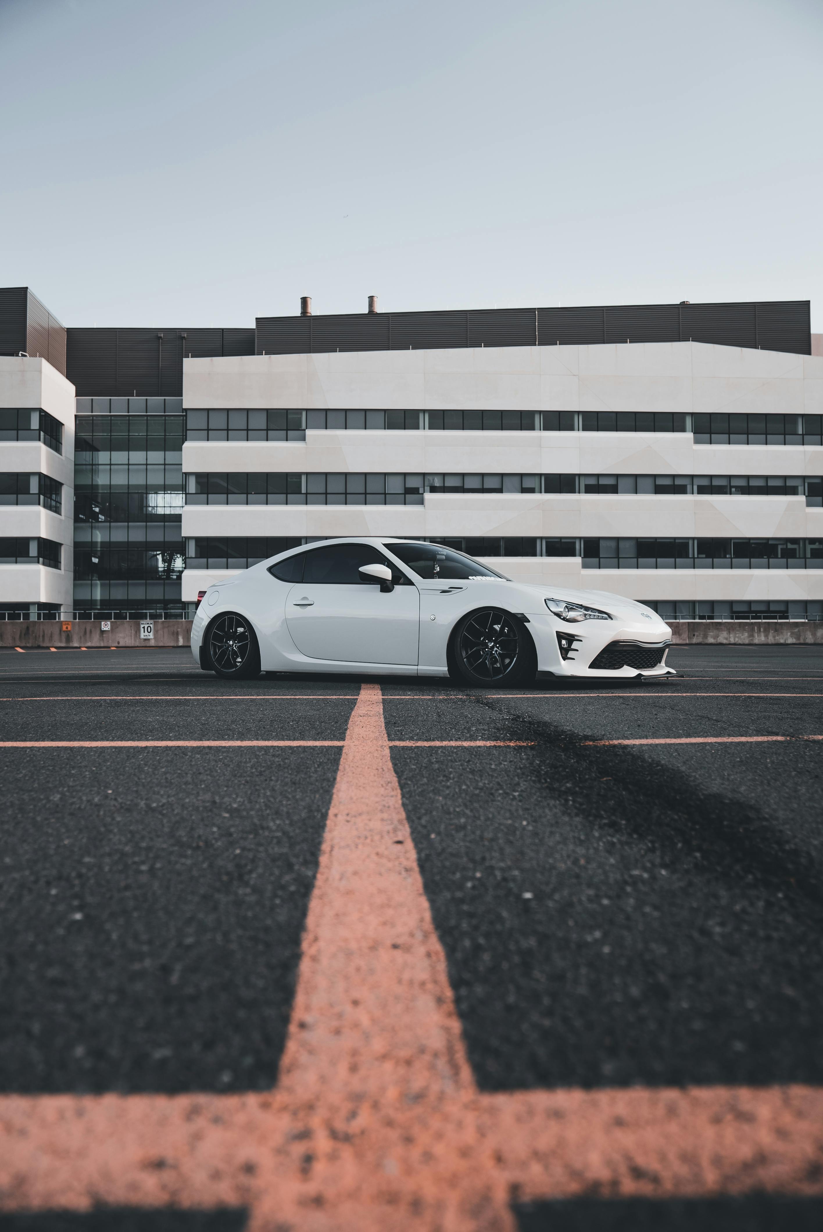 sleek white sports car on asphalt lot