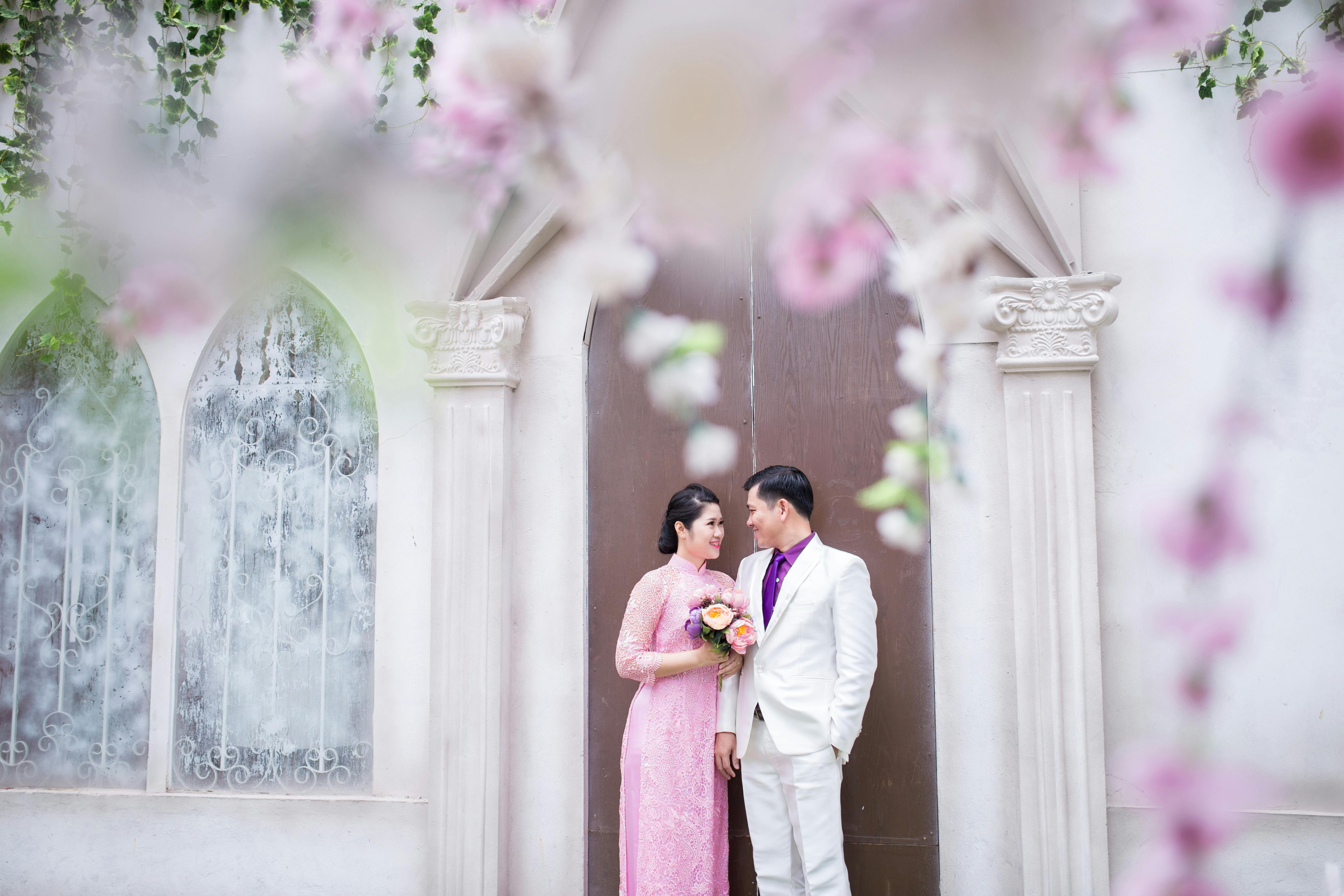 photo of couple smiling while looking at each other