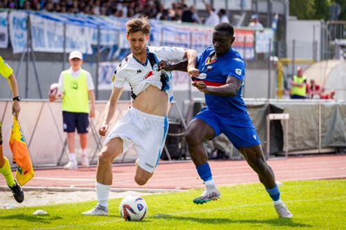 Free A dynamic capture of two soccer players competing fiercely for possession during a game. Stock Photo