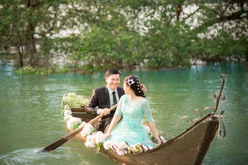 Smiling Couple Looking at each other While Riding on a Boat